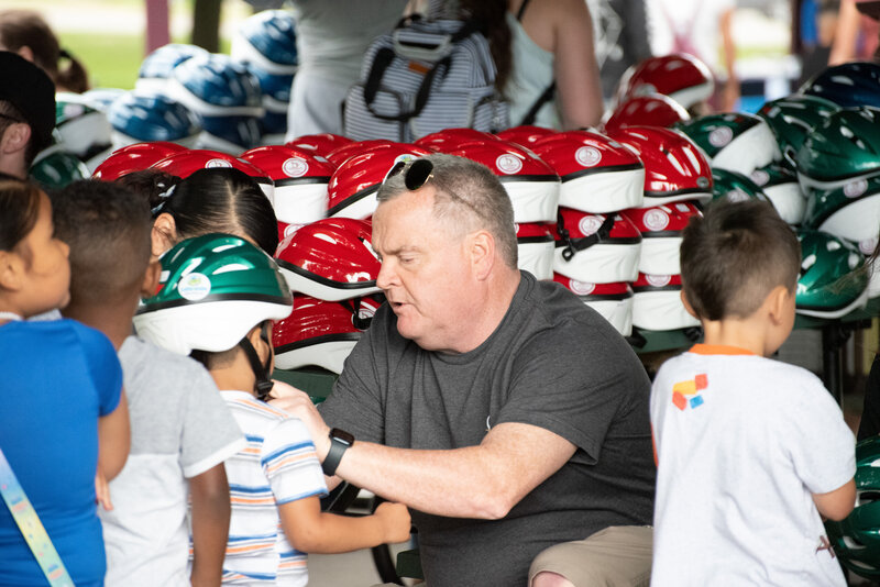 Brian McKenna - fitting helmet on child
